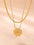 2 piece 18K gold-plated inlaid zircon lucky clover necklace on beige background.