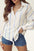 Stripe drop shoulder long sleeve shirt in white with blue stripes, button-up design, paired with denim shorts.