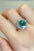 5 Carat Moissanite 925 Sterling Silver Ring with green gemstone on hand.