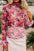 Floral turtleneck flounce sleeve blouse with pink patterns.