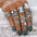 Alloy 16-piece ring set featuring opal and synthetic crystal designs on a hand.