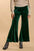 Umgee high rise elastic waist flare pants in green velvet, showcasing chic retro style and comfort.