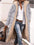 Full size zip up Sherpa hooded coat in gray, worn by a person outdoors, styled with jeans and a layered shirt.