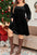 Plus size smocked square neck long sleeve dress in black, worn by a model in front of a Christmas tree.