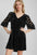 Umgee black velvet mini dress with dotted lace sleeves and tiered skirt.