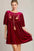 Umgee embroidered half sleeve velvet mini dress with tassel in rich red color.