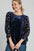 Umgee Polka Dot Lace Long Sleeve Round Neck Blouse with openwork detailing.